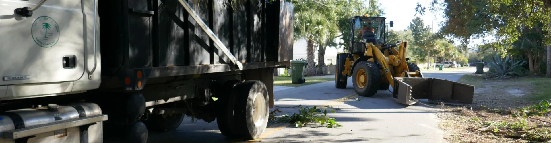 A digger cleaning the streets of debris.