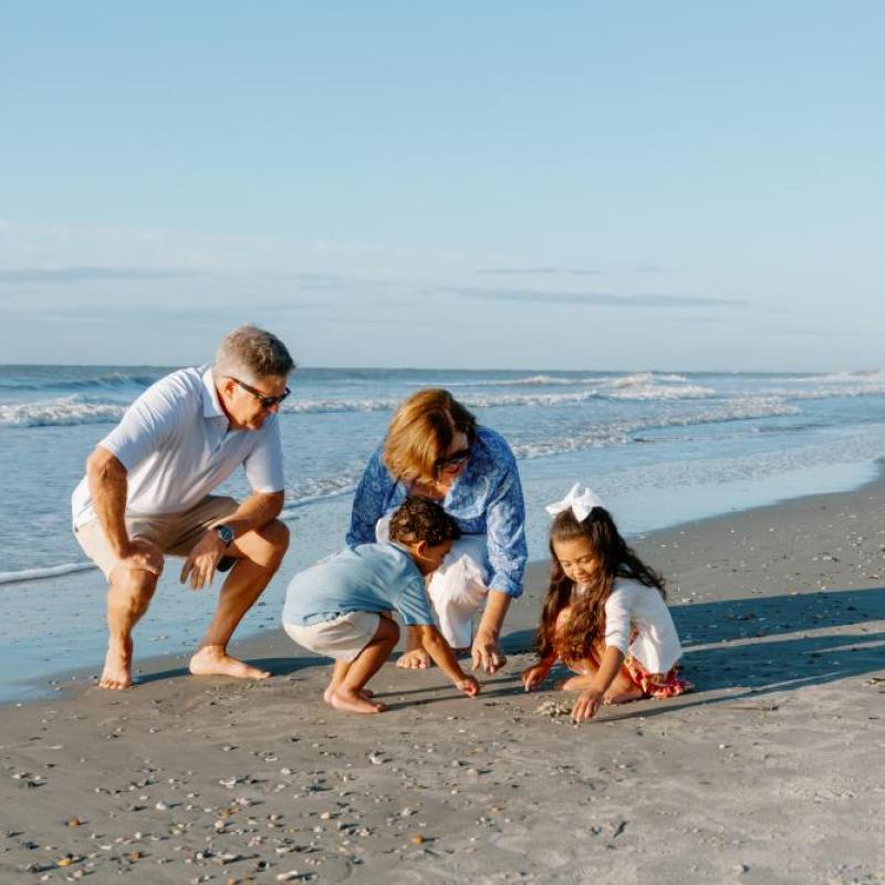 Grandparents with grandchildren on the beach